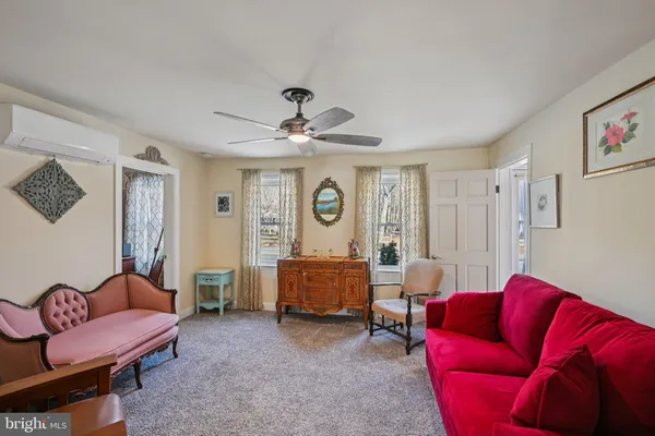 a bedroom with furniture and a flat screen tv