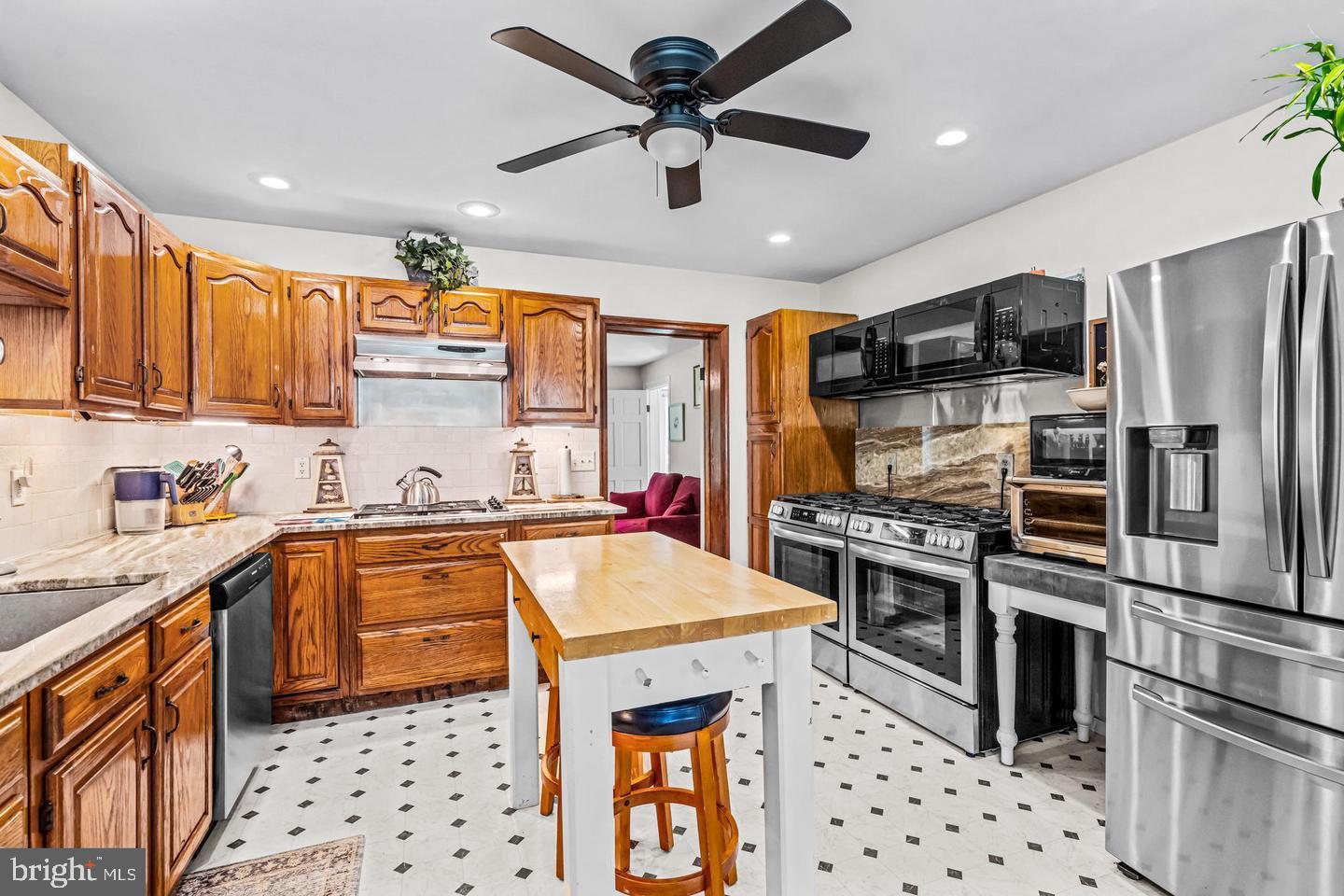 668 Crawford Road Cape May, NJ 08204 - Photo 23 of 66 a kitchen with stainless steel appliances a stove a sink dishwasher a refrigerator and cabinets with wooden floor