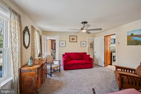 a bedroom with a bed and a large mirror on the dresser