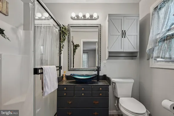 a spacious bedroom with a bed and a dresser