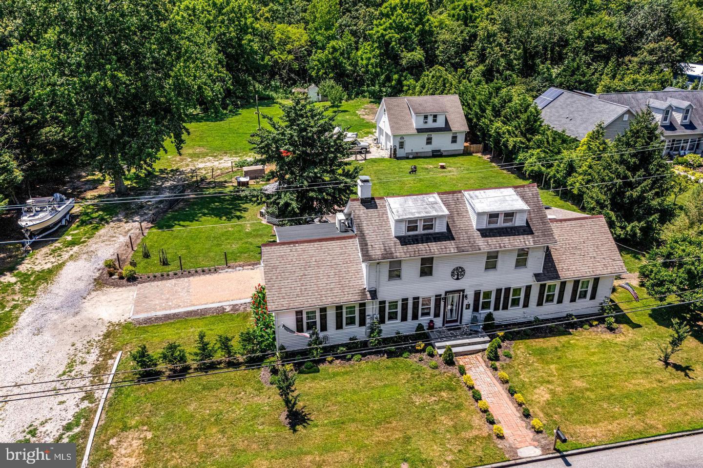 668 Crawford Road Cape May, NJ 08204 - Photo 3 of 66 an aerial view of a house with swimming pool and large trees