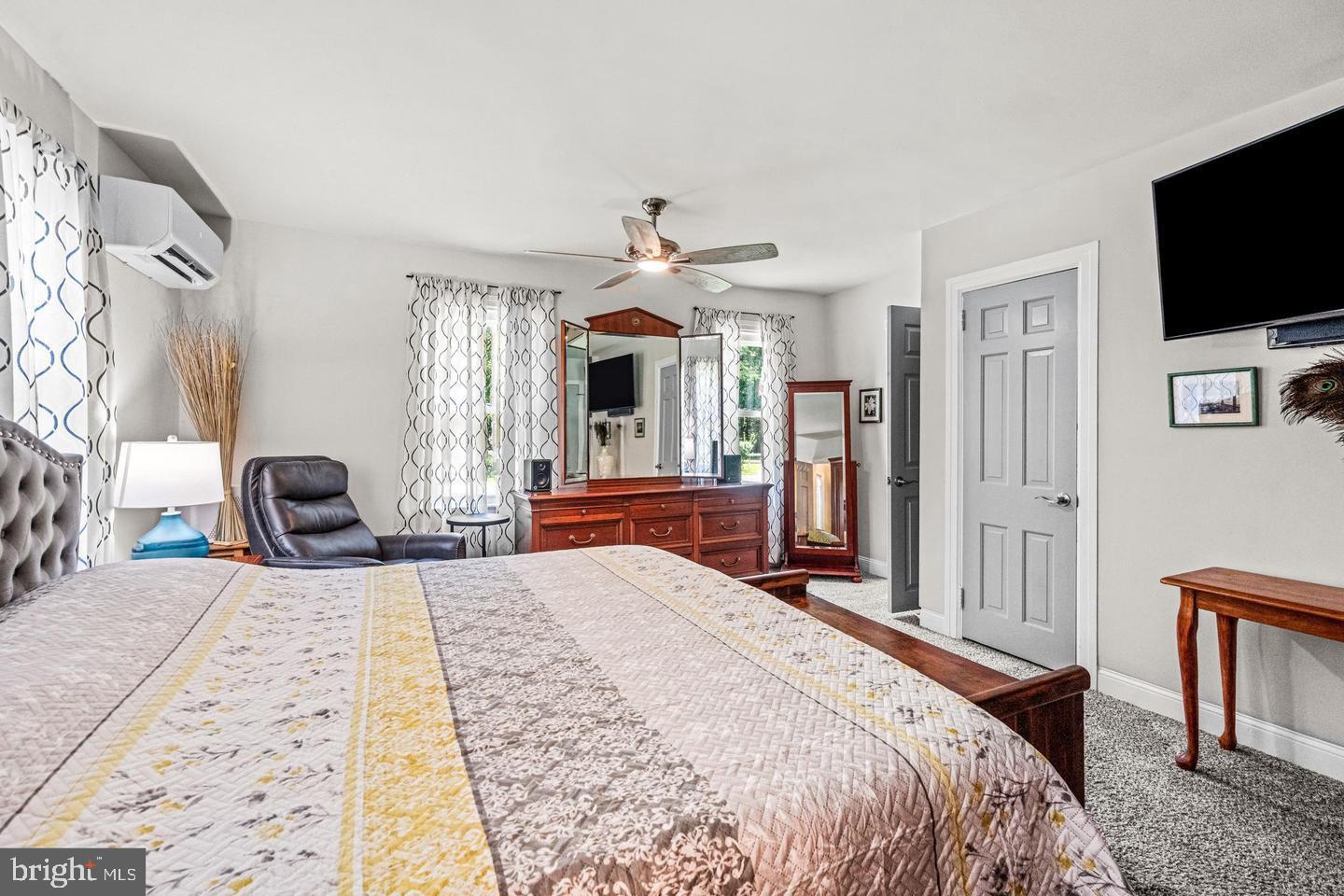 668 Crawford Road Cape May, NJ 08204 - Photo 35 of 66 a bedroom with a large bed a flat tv screen and large dresser