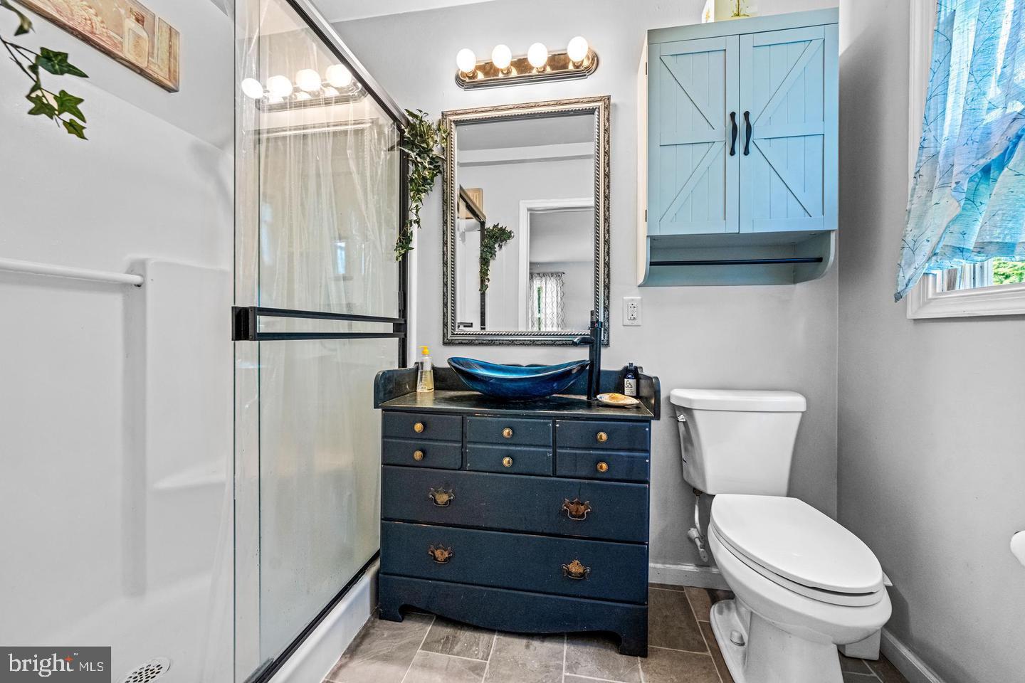668 Crawford Road Cape May, NJ 08204 - Photo 36 of 66 a bathroom with a toilet a sink and a mirror