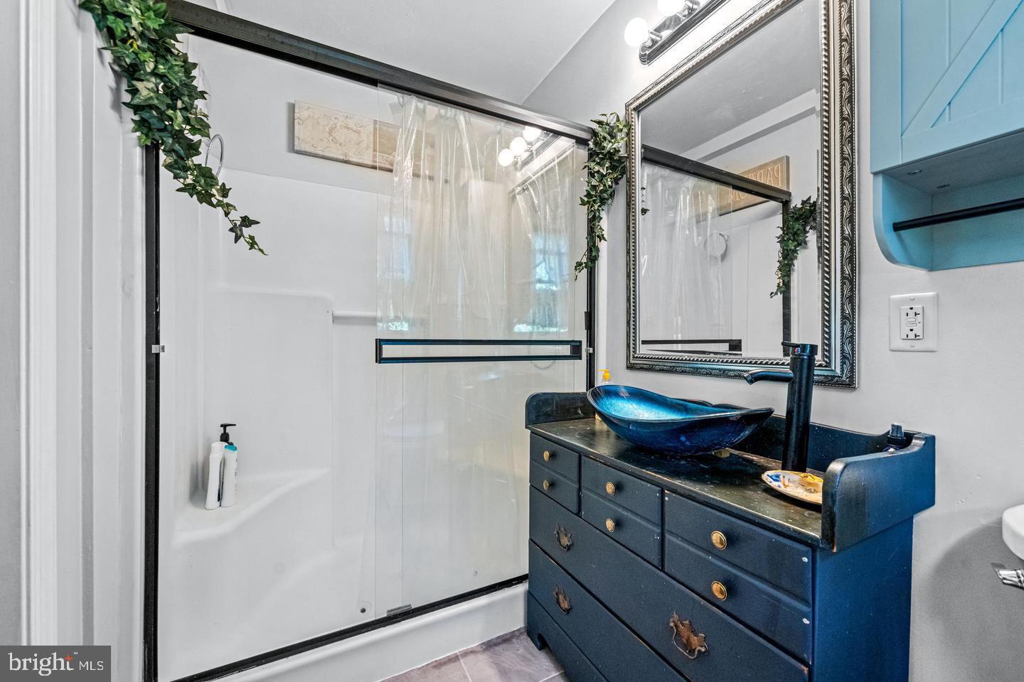 668 Crawford Road Cape May, NJ 08204 - Photo 37 of 66 a bathroom with a mirror and a sink