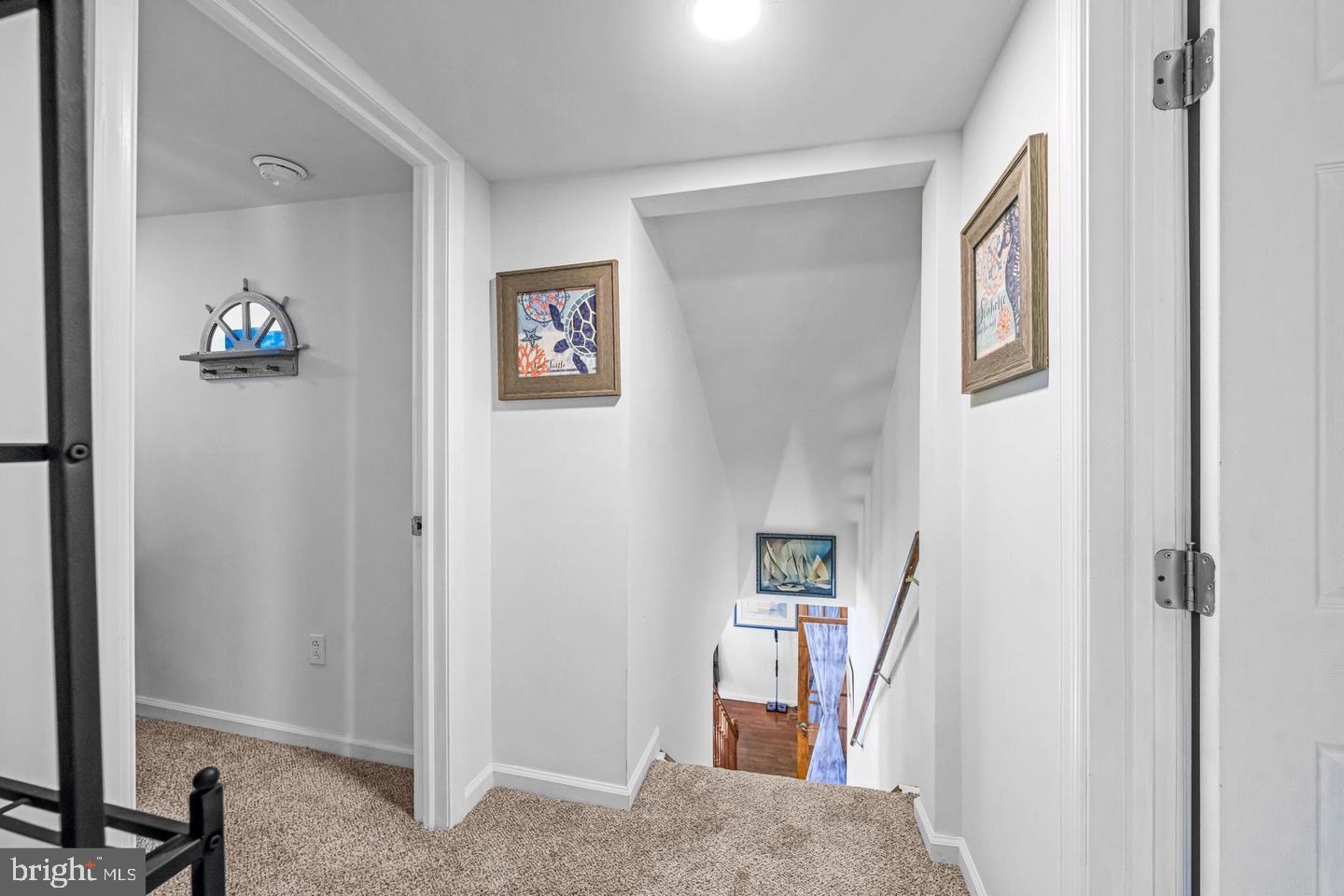 668 Crawford Road Cape May, NJ 08204 - Photo 39 of 66 a view of a hallway with paintings on the wall