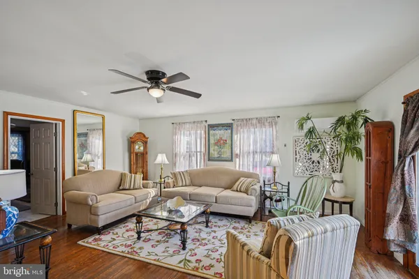 a living room with furniture a dining table and chairs with outer view