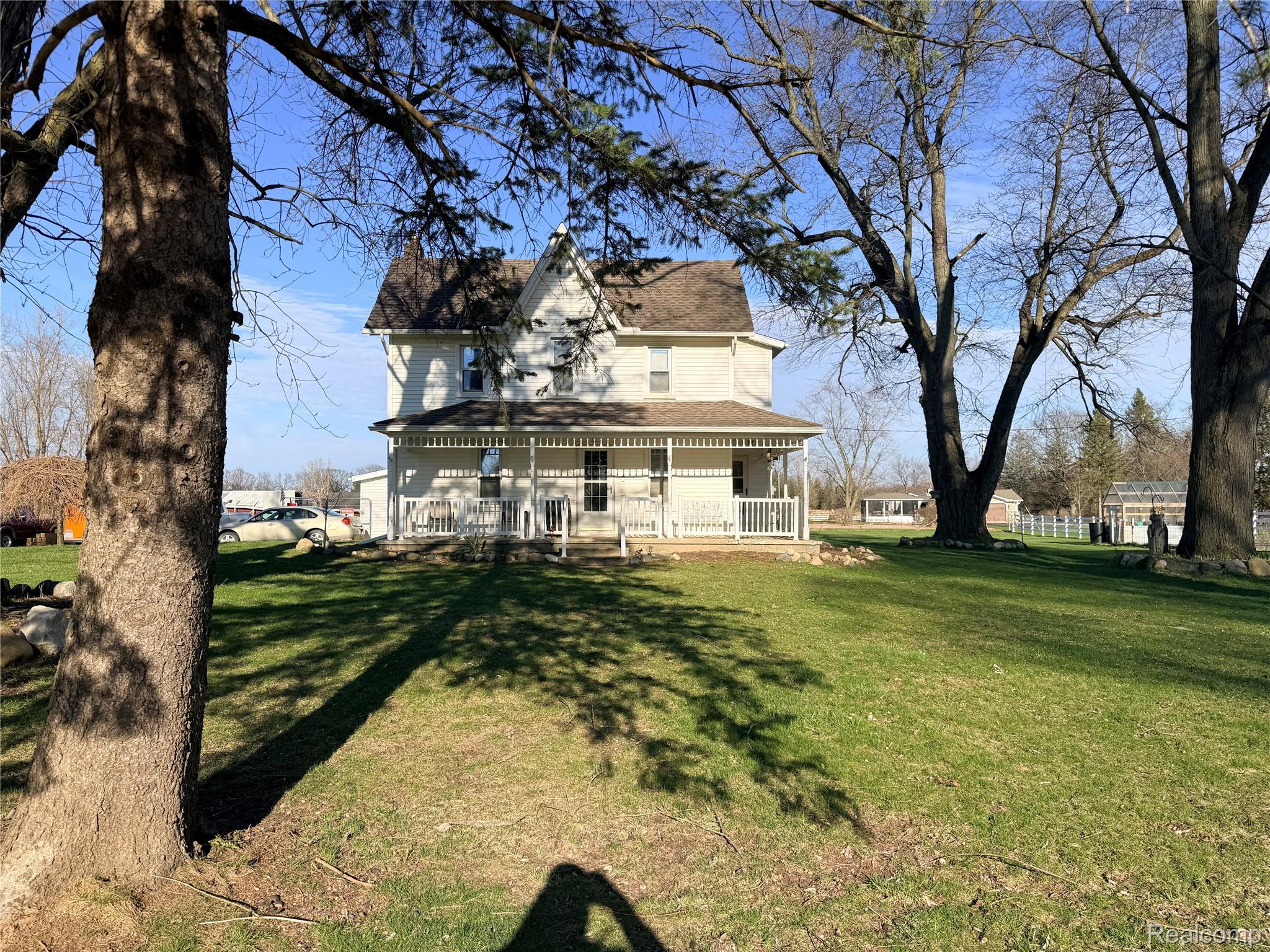 6038 Byron Road Howell, MI 48855 - Photo 1 of 24 Back of house with a large porch, a lawn, and roof with shingles