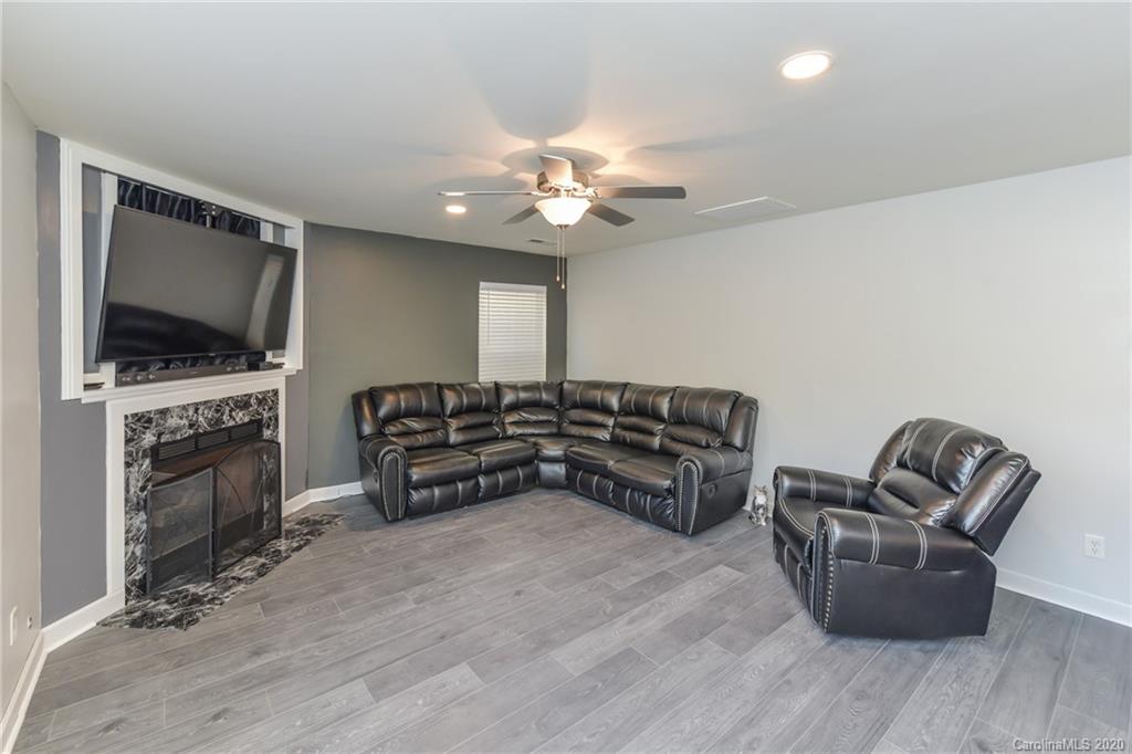 717 Jones Branch Road Fort Mill, SC 29715 - Photo 13 of 31 a living room with furniture and a flat screen tv
