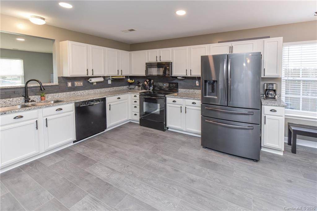 717 Jones Branch Road Fort Mill, SC 29715 - Photo 4 of 31 a kitchen with a refrigerator stove and sink