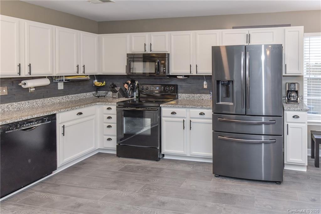 717 Jones Branch Road Fort Mill, SC 29715 - Photo 5 of 31 a kitchen with stainless steel appliances granite countertop a refrigerator stove a sink and dishwasher