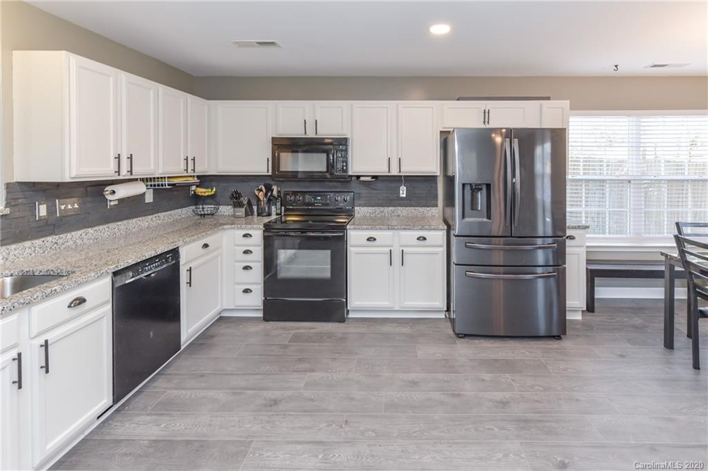 717 Jones Branch Road Fort Mill, SC 29715 - Photo 6 of 31 a kitchen with stainless steel appliances granite countertop a refrigerator stove a sink and dishwasher