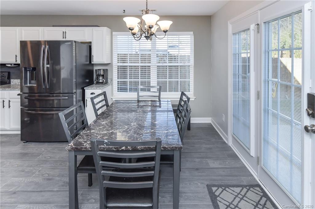 717 Jones Branch Road Fort Mill, SC 29715 - Photo 9 of 31 a kitchen with kitchen island a counter top space and stainless steel appliances