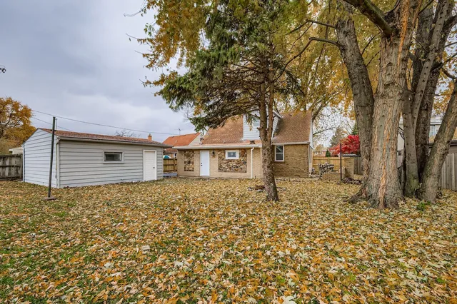 a backyard of a house with table and chairs