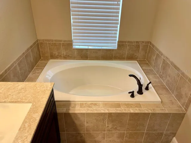 an empty room with sliding door and mirror