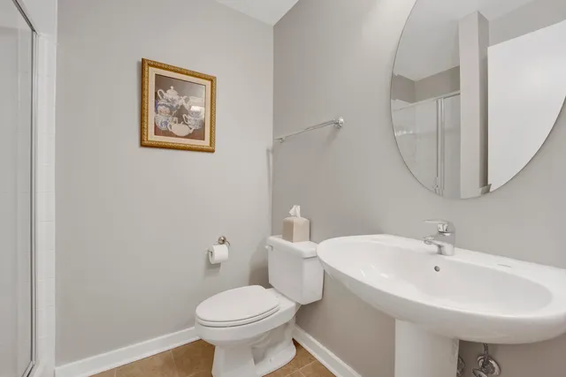 a bathroom with a sink mirror and toilet