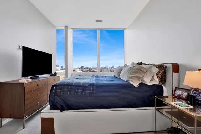 a bedroom with a bed and a flat screen tv