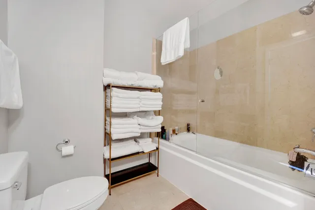 a bathroom with a sink a toilet and bathtub