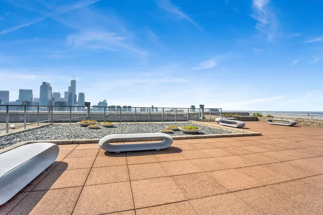 a view of swimming pool with outdoor seating and city view