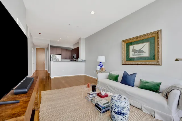 a living room with furniture and kitchen view