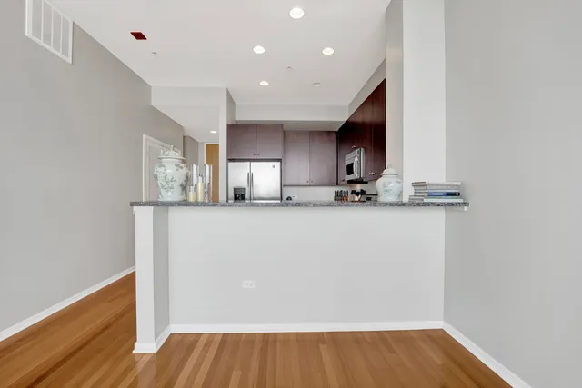 a room with wooden floor and cabinets