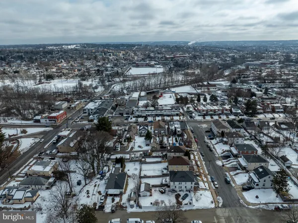 an aerial view of multiple houses with yard