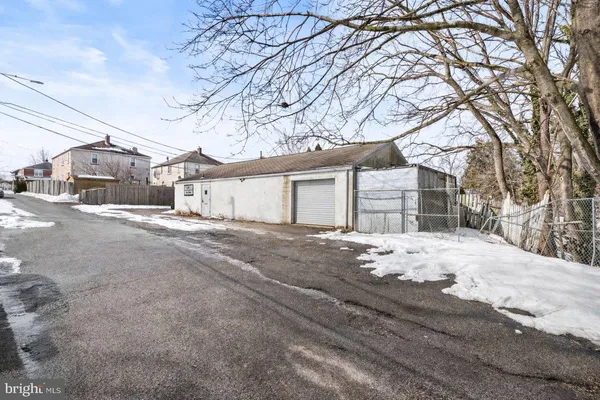 a view of a house with snow on the road