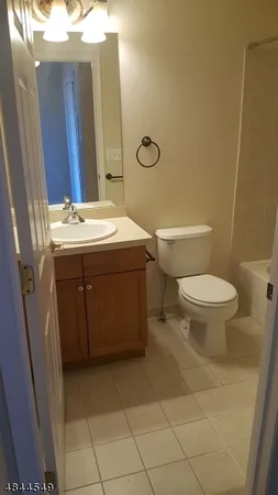 a bathroom with a sink toilet and mirror