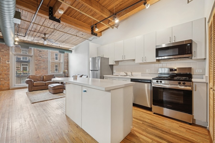 420 South Clinton Street, Unit 614A Chicago, IL 60607 - Photo 2 of 10 a kitchen with stainless steel appliances a stove a sink and a microwave