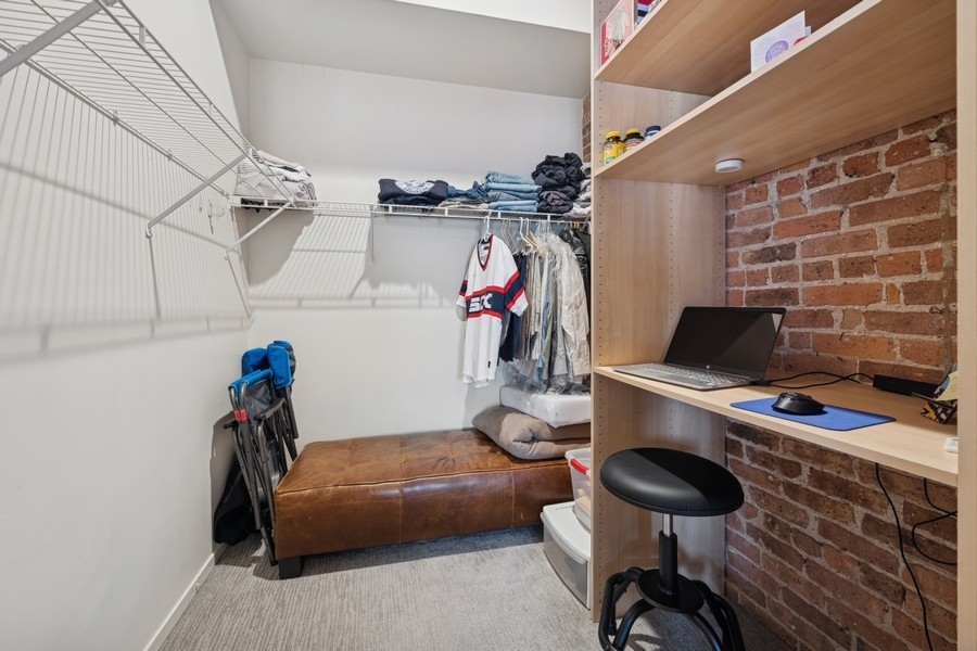 420 South Clinton Street, Unit 614A Chicago, IL 60607 - Photo 8 of 10 a bedroom with a bed and a chandelier