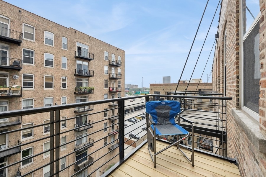 420 South Clinton Street, Unit 614A Chicago, IL 60607 - Photo 10 of 10 a view of a balcony with chairs and wooden floor