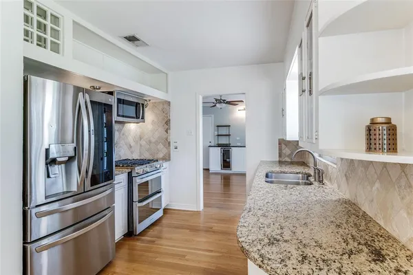 a kitchen with a refrigerator and a sink