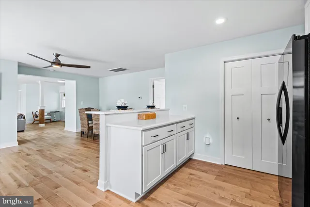 a kitchen with stainless steel appliances a refrigerator and a stove top oven