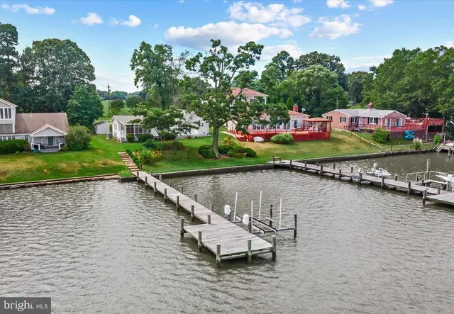 an aerial view of a houses with outdoor space and lake view