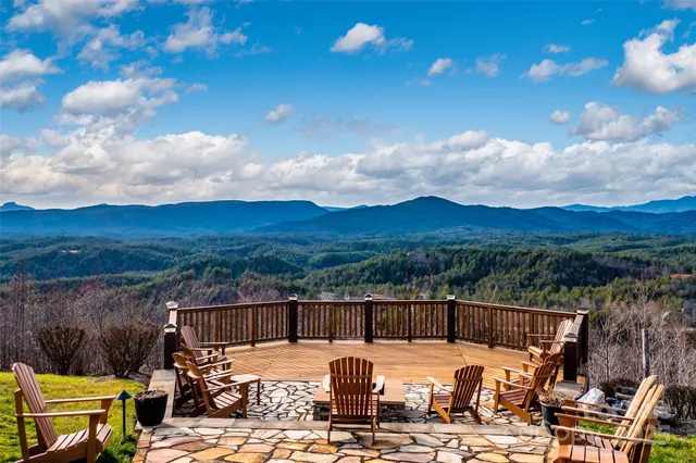 a view of a swimming pool with a patio and a yard