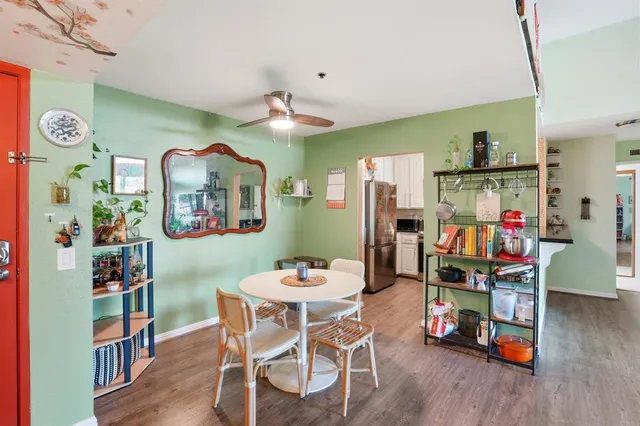 a dining room with furniture and wooden floor