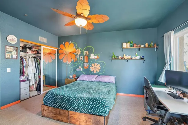 a bedroom with a bed and dresser