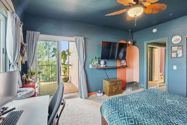 a bedroom with furniture and a large window