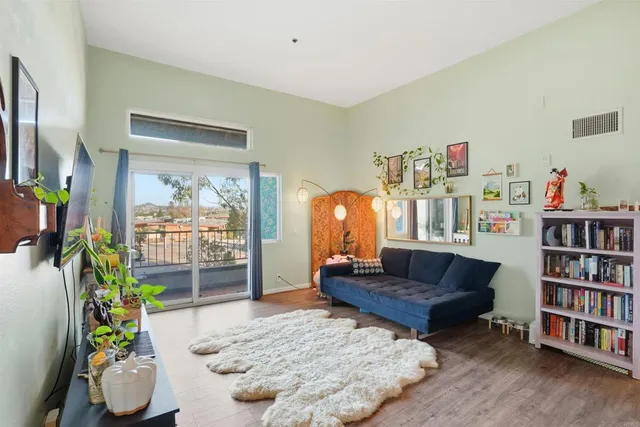 a living room with furniture and a book shelf