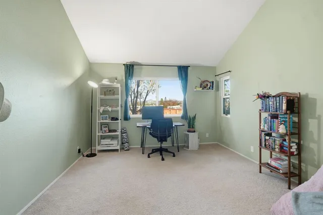 a view of a workspace with furniture and a bathroom