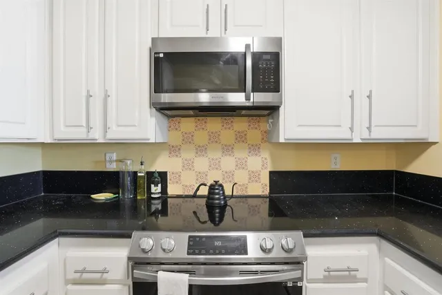 a kitchen with a stove and cabinets