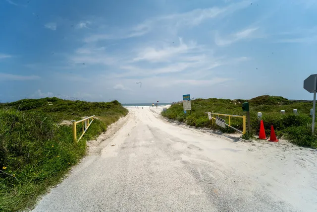 a view of balcony with wooden floor and fence