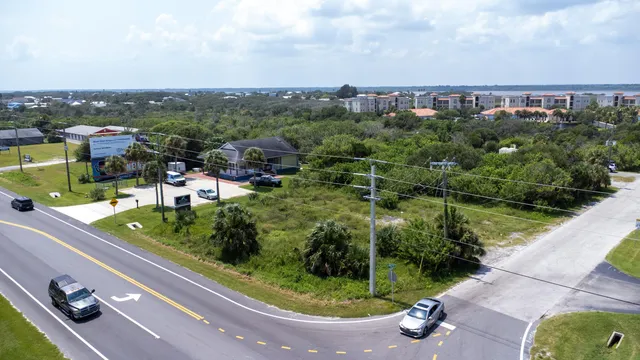 an aerial view of lake and residential houses with outdoor space