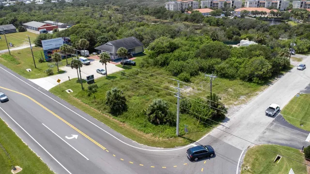 an aerial view of a house with garden space and street view