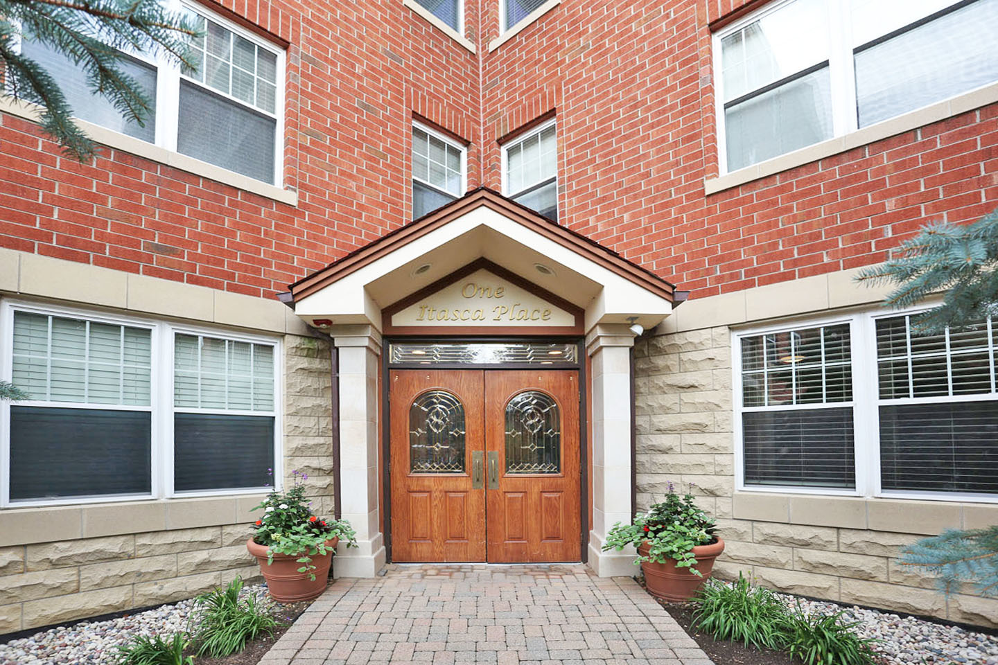 1 Itasca Place, Unit 304 Addison, IL 60143 - Photo 2 of 25 a front view of a house with garden