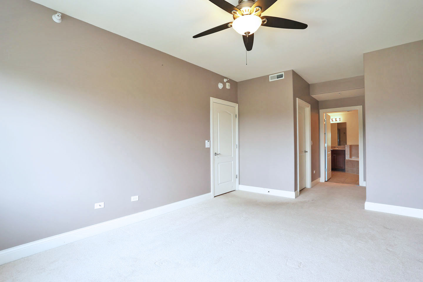1 Itasca Place, Unit 304 Addison, IL 60143 - Photo 12 of 25 an empty room with closet and a chandelier fan