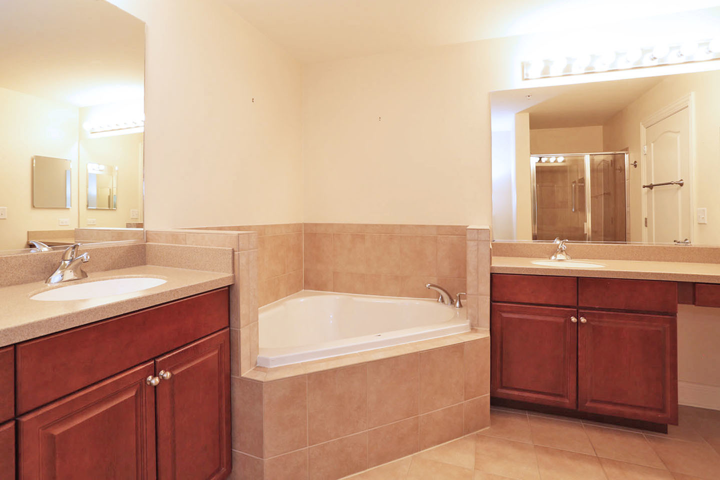 1 Itasca Place, Unit 304 Addison, IL 60143 - Photo 15 of 25 a bathroom with a tub sink and mirror