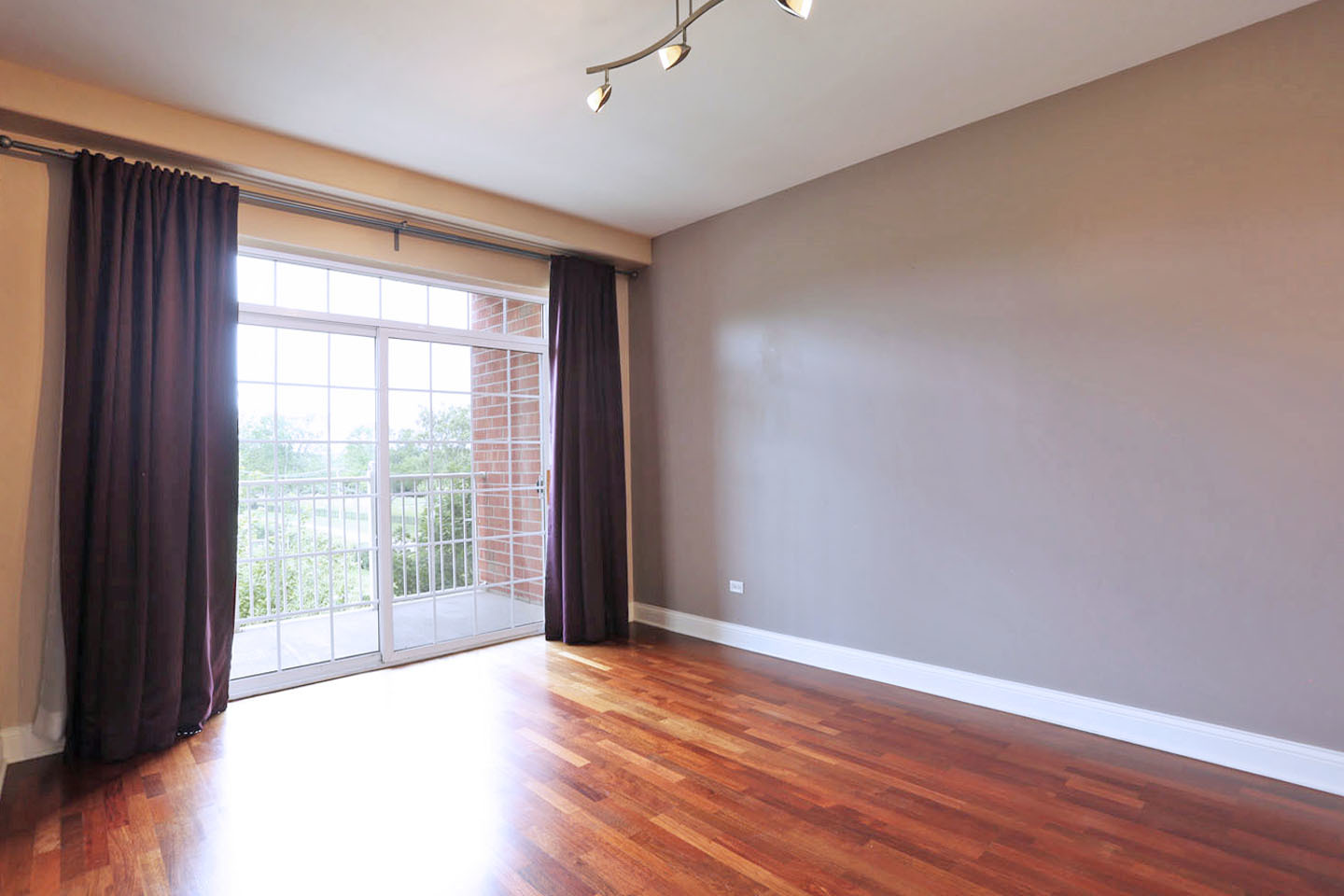 1 Itasca Place, Unit 304 Addison, IL 60143 - Photo 4 of 25 a view of an empty room with wooden floor and a window