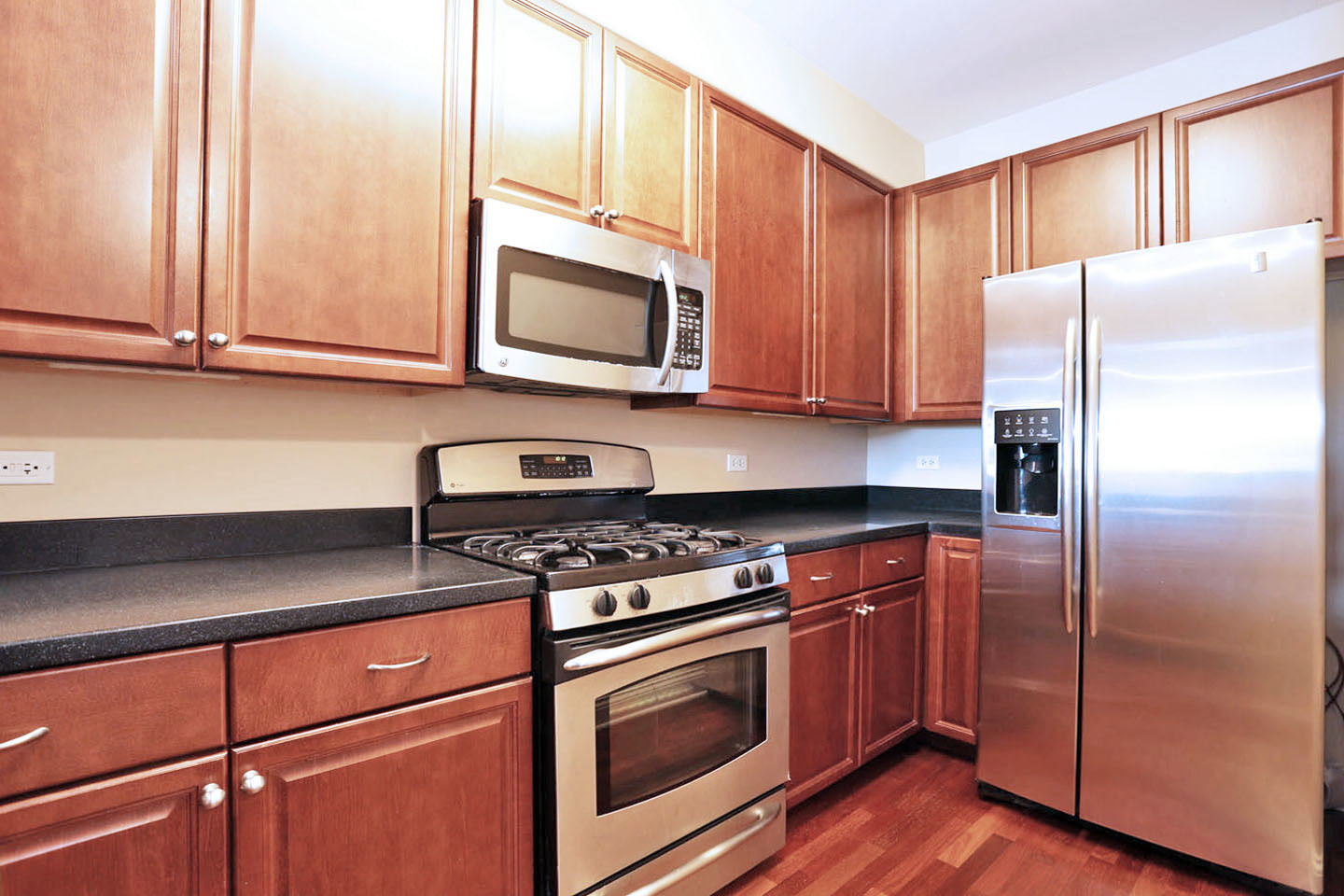 1 Itasca Place, Unit 304 Addison, IL 60143 - Photo 8 of 25 a kitchen with stainless steel appliances granite countertop a refrigerator stove and microwave