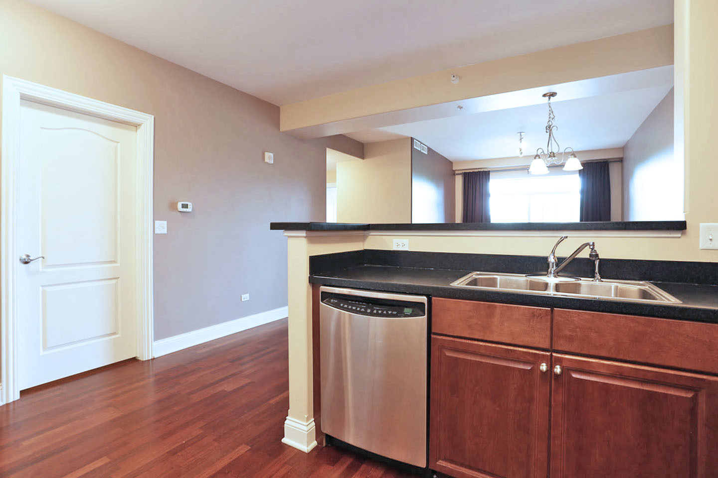 1 Itasca Place, Unit 304 Addison, IL 60143 - Photo 10 of 25 a kitchen with a sink and wooden floor