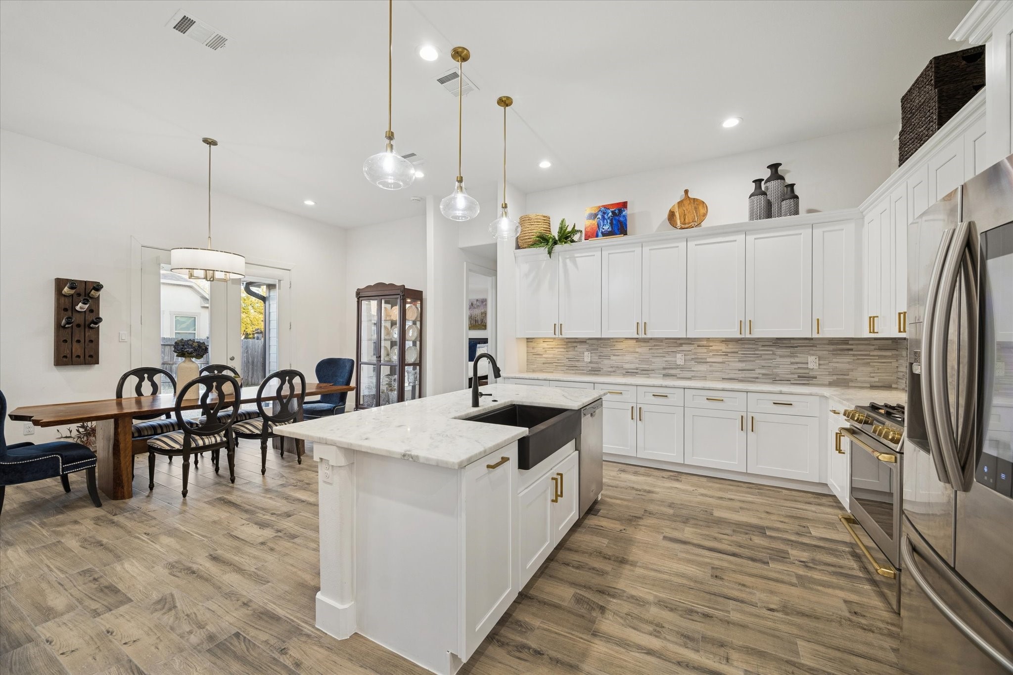 203 Hampton Glen Road Montgomery, TX 77356 - Photo 11 of 28 This angle highlights the kitchen from the left side, showcasing this truly unique and inviting space. Fully equipped and thoughtfully designed, it’s ready for you and your family to start enjoying this beautiful home. The kitchen inspires creativity, making it the perfect place to explore new recipes and make the most of every element in this space.